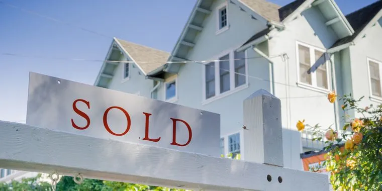 an image of a house with a sign in front that says "sold".
