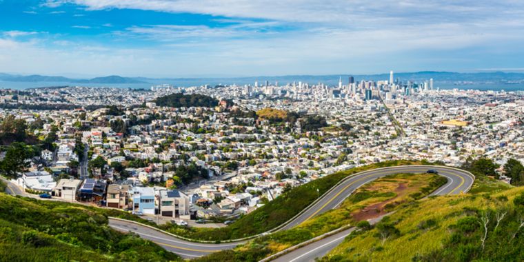 A view of the city of San Francisco looking east on a big hill.